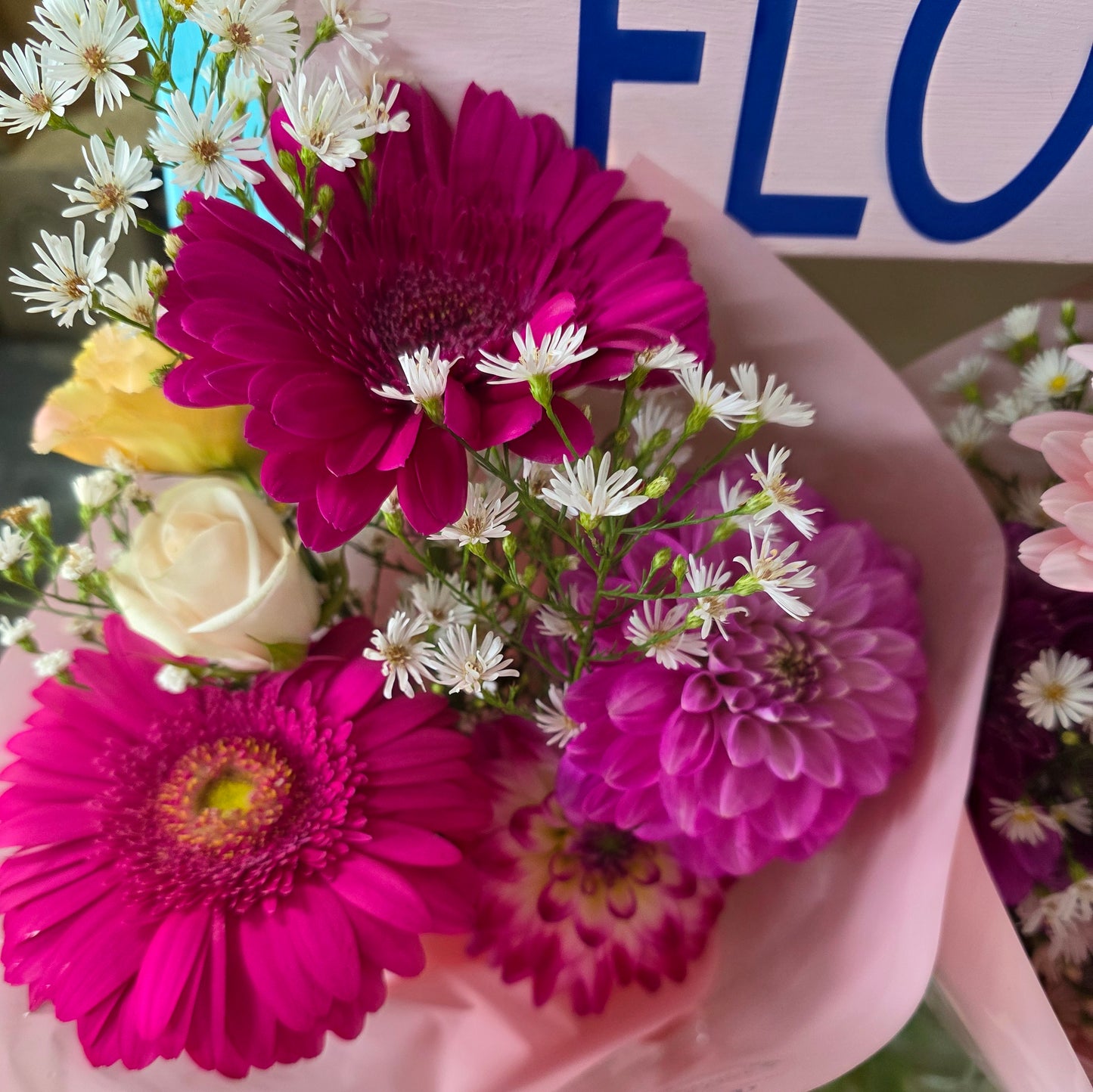 Bouquet of flowers with pink and purple flowers in a pink 
