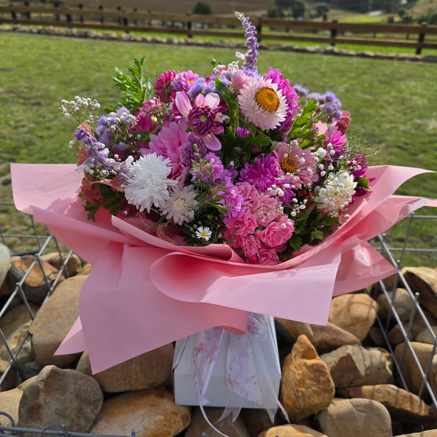 Bouquet of flowers wrapped in pink paper 