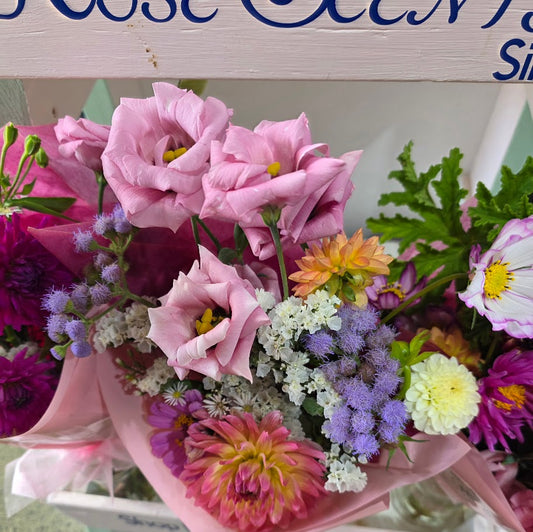Bouquet of colorful flowers with a wooden sign in the background